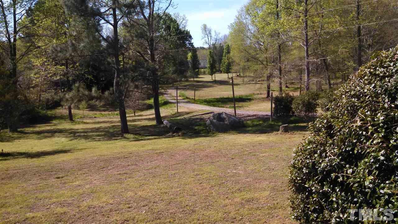2001 Sanders Road Stem, NC 27581 - Photo 18 of 21 a view of a yard with trees