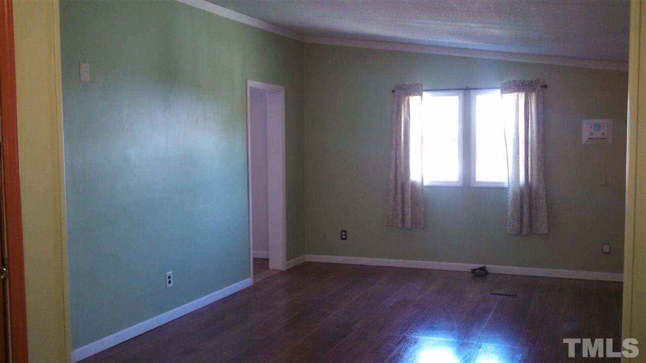 2001 Sanders Road Stem, NC 27581 - Photo 5 of 21 an empty room with wooden floor and windows