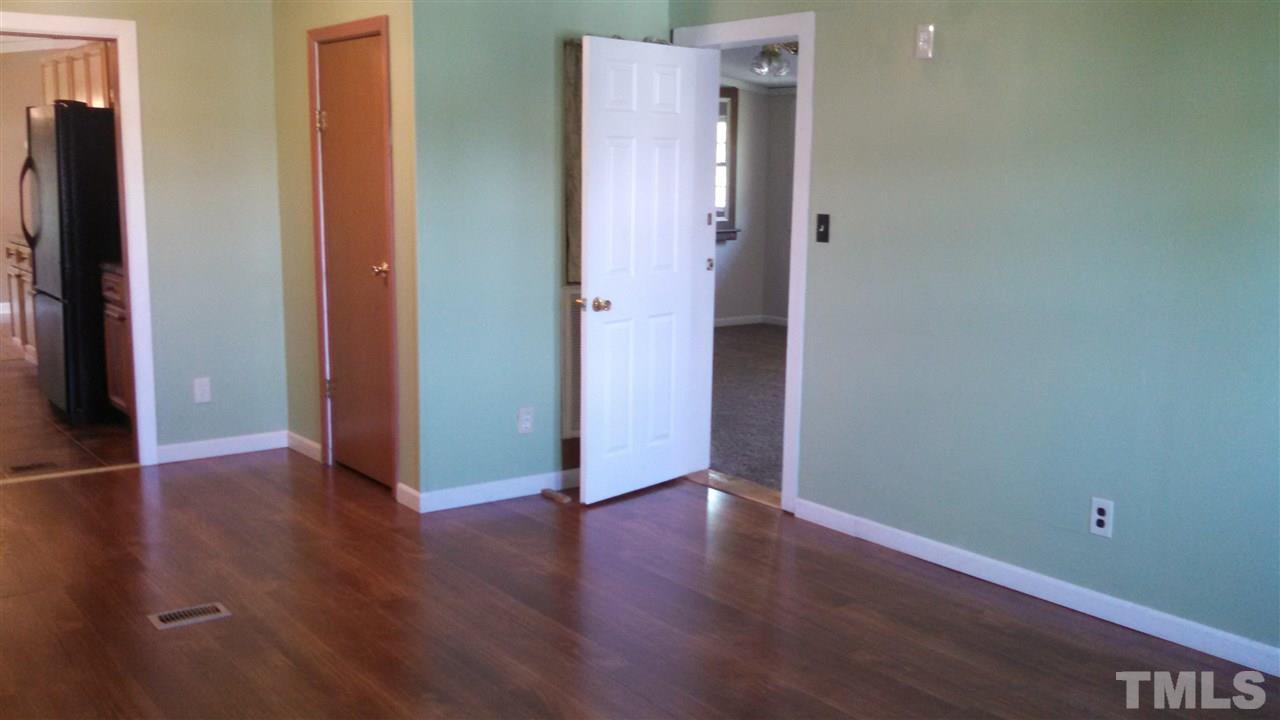 2001 Sanders Road Stem, NC 27581 - Photo 6 of 21 an empty room with wooden floor and closet