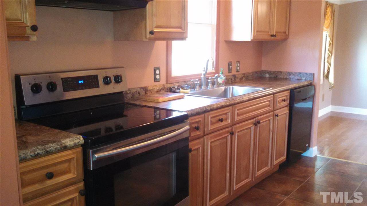2001 Sanders Road Stem, NC 27581 - Photo 8 of 21 a kitchen with granite countertop a sink stove and cabinets