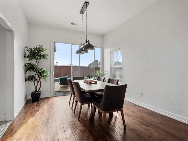 a living room with furniture a large window and a fireplace