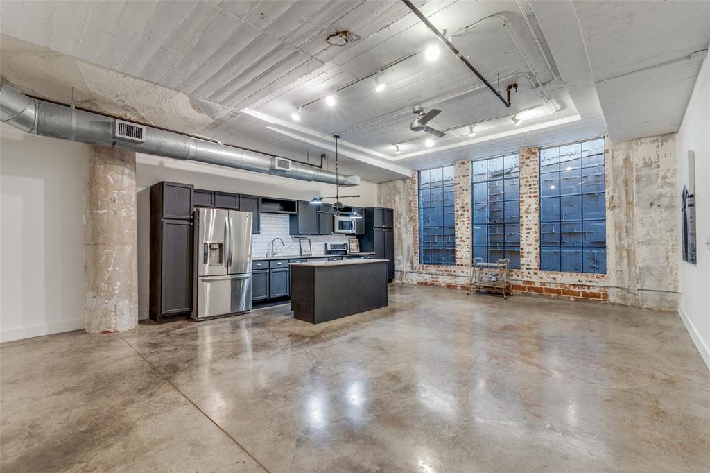 1122 Jackson Street, Unit 922 Dallas, TX 75202 - Photo 13 of 25 a view of a big room with wooden cabinet and windows