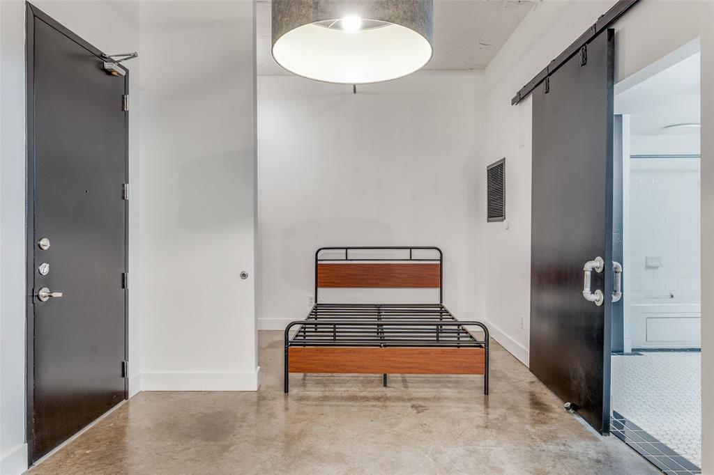 1122 Jackson Street, Unit 922 Dallas, TX 75202 - Photo 6 of 25 a room with wooden floor and a window