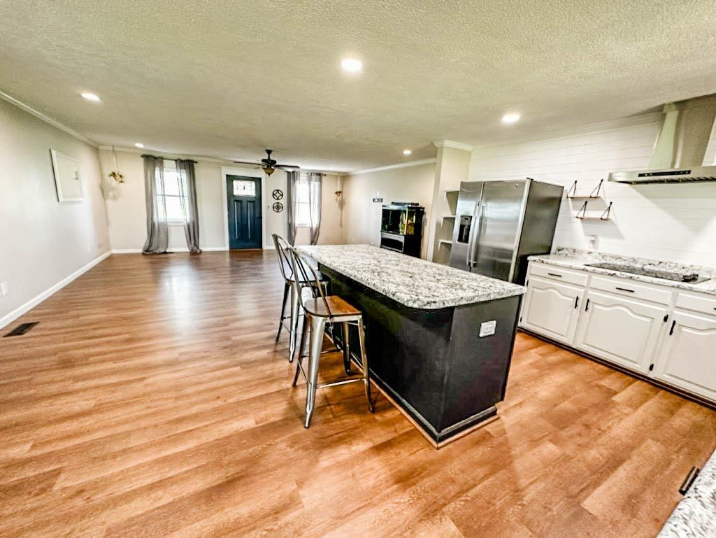 888 Jones Road Bells, TN 38006 - Photo 10 of 21 a living room with stainless steel appliances kitchen island granite countertop a table chairs and a refrigerator