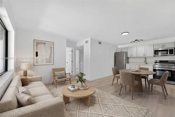 a living room with furniture and kitchen view