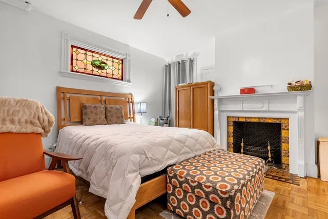 a bedroom with a bed and a fireplace