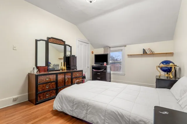 a bedroom with a bed and a large mirror