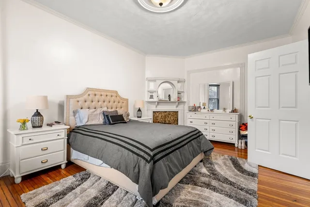 a bedroom with a bed and a dresser in it