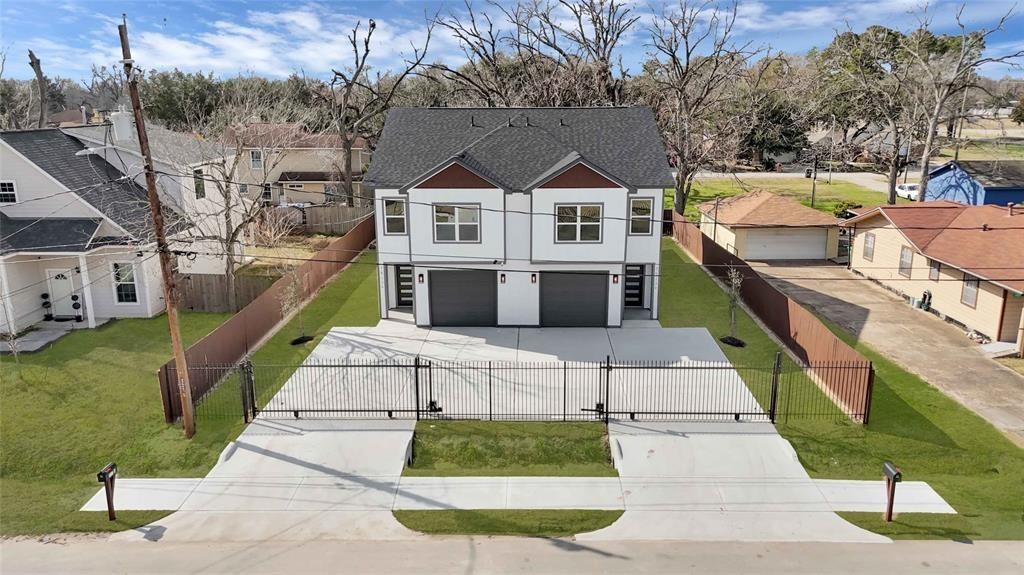 7517 Hezekiah Lane, Unit A Houston, TX 77088 - Photo 2 of 13 a view of multiple houses with a yard