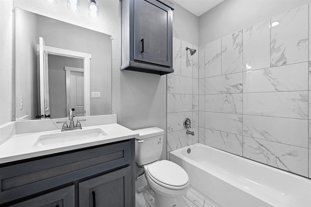 7517 Hezekiah Lane, Unit A Houston, TX 77088 - Photo 9 of 13 a bathroom with a sink a toilet and bathtub