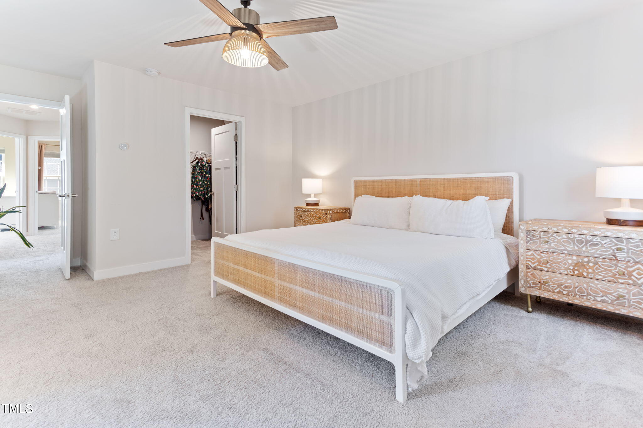 4765 Randall Road Durham, NC 27707 - Photo 17 of 30 a bedroom with a bed and ceiling fan