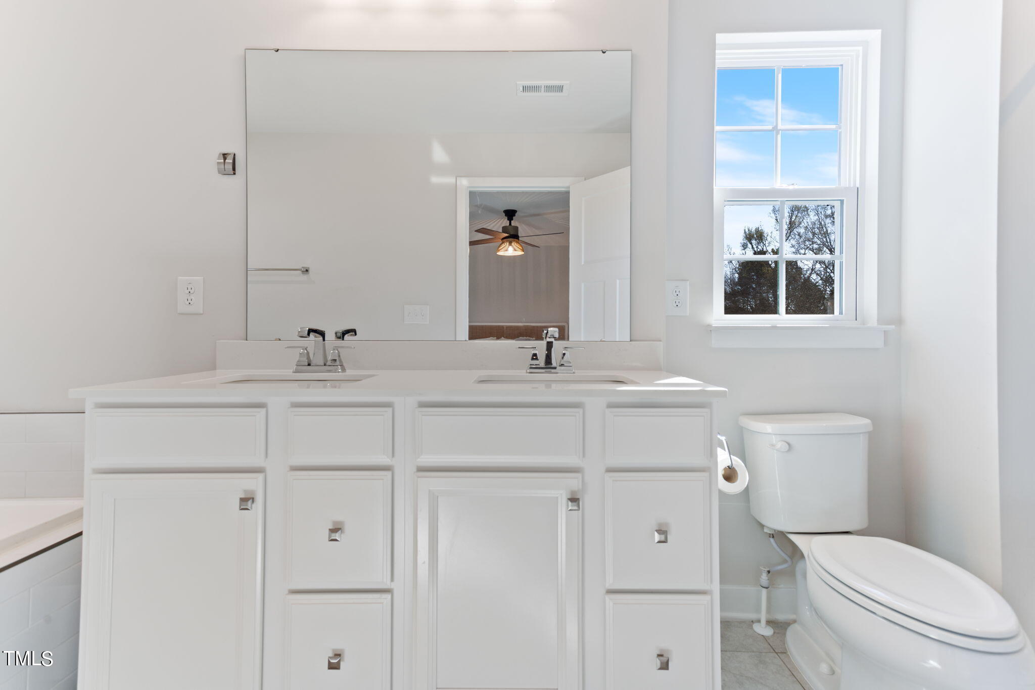 4765 Randall Road Durham, NC 27707 - Photo 24 of 30 a bathroom with a toilet sink and mirror