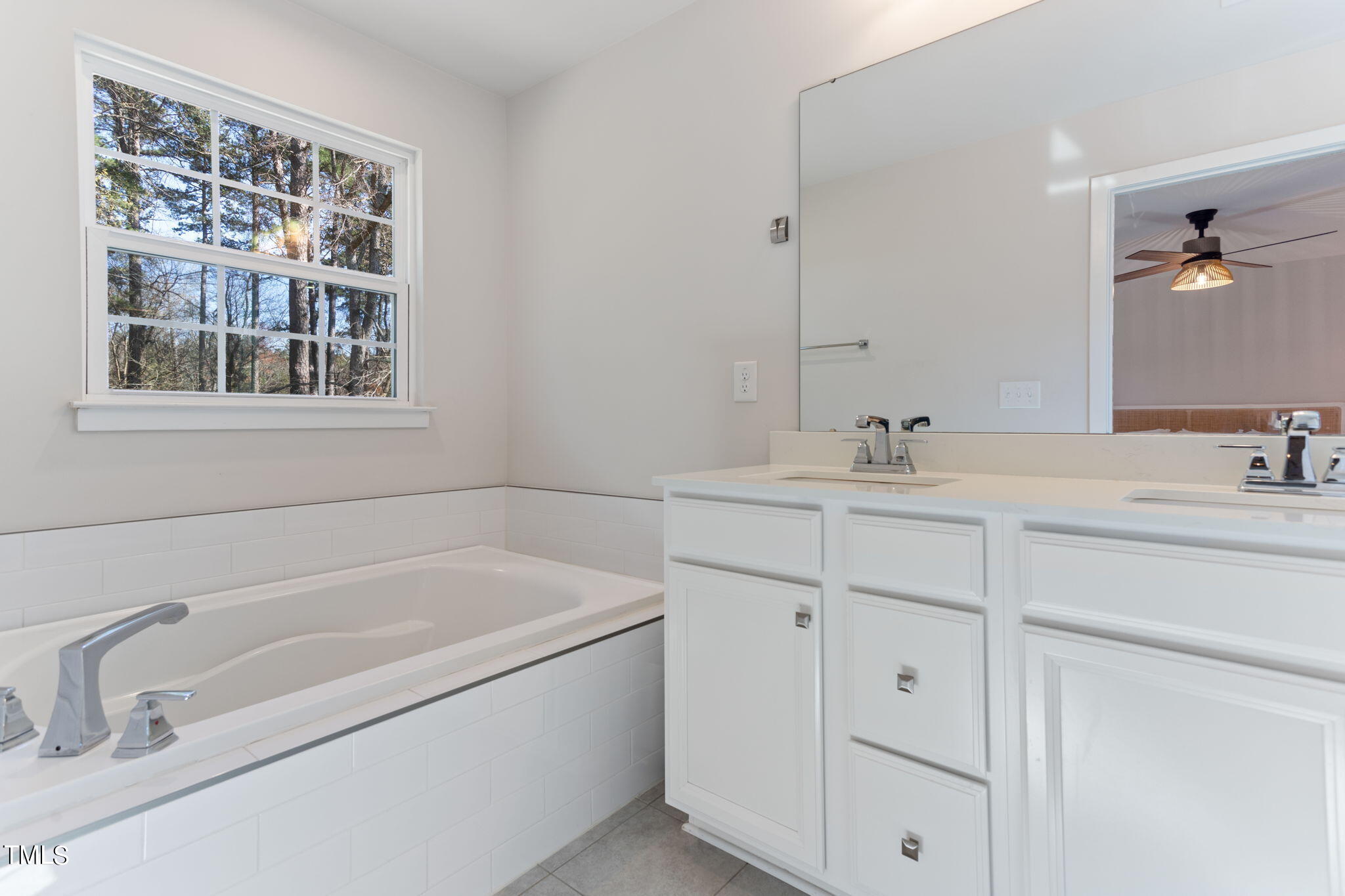 4765 Randall Road Durham, NC 27707 - Photo 26 of 30 a bathroom with a tub sink and mirror
