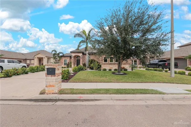 a view of a white house with a yard