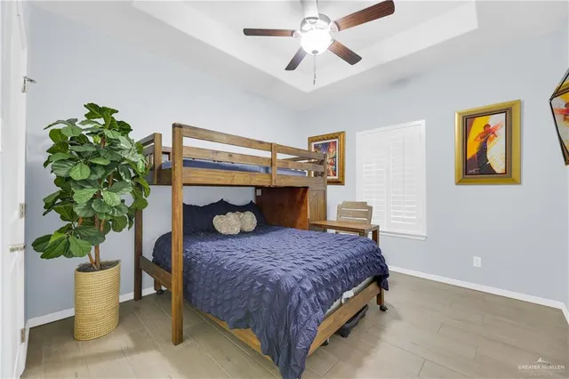 a bedroom with a bed and a potted plant