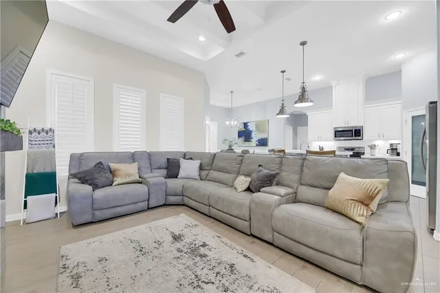 a living room with furniture and kitchen view