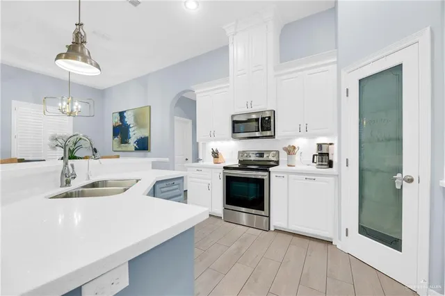 a kitchen with a sink a stove and refrigerator