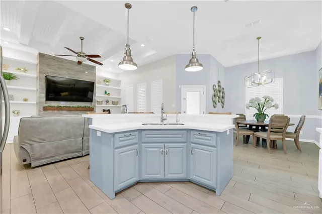 a large kitchen with sink and microwave