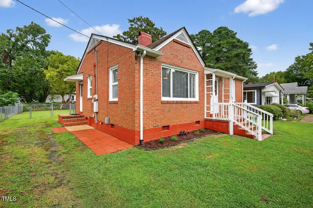 a view of a house with a yard and deck