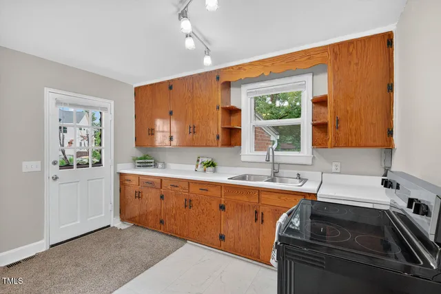 a kitchen that has a sink and a stove in it