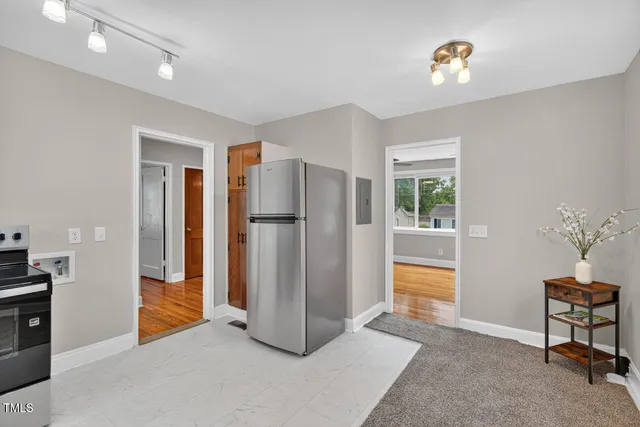 a view of kitchen with refrigerator and window