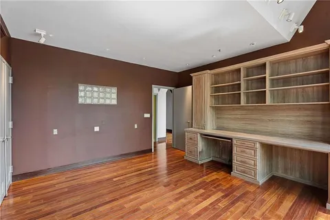 a view of kitchen with wooden floor and electronic appliances