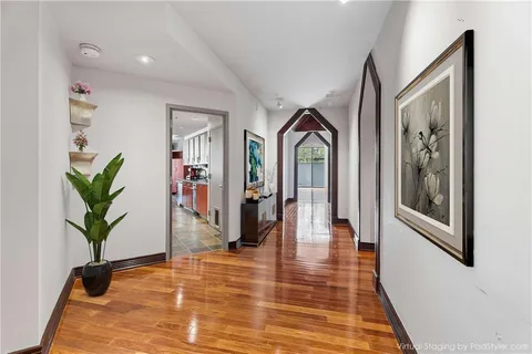 a view of an entryway with wooden floor