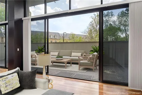 a view of a living room with furniture and floor to ceiling windows