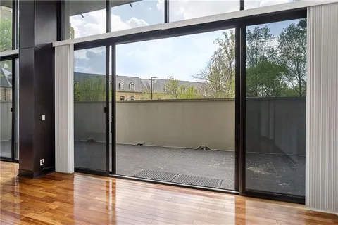 a view of a room with wooden floor and windows