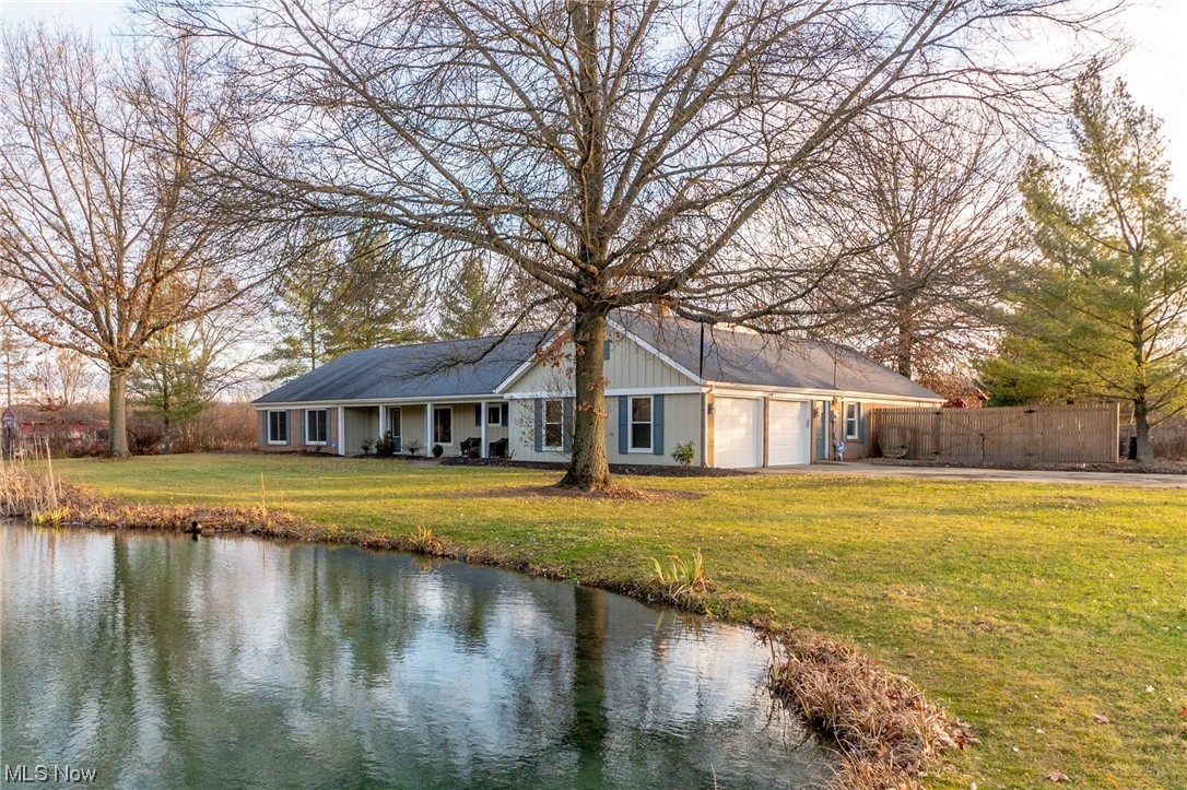 4529 Beat Road Litchfield, OH 44253 - Photo 2 of 42 View of front of property featuring a front lawn and a water view