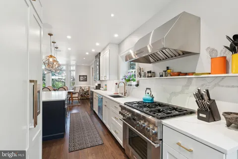 a view of a dining room with furniture and a chandelier