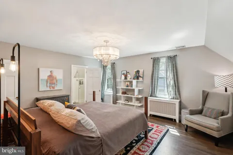 a bedroom with a large bed and a flat screen tv