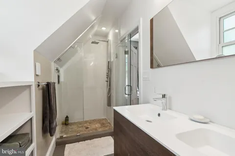 a bedroom with a bed dresser and a window