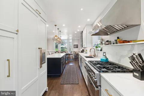 a dining room with furniture a chandelier and wooden floor