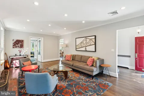 a dining room with furniture a chandelier and wooden floor