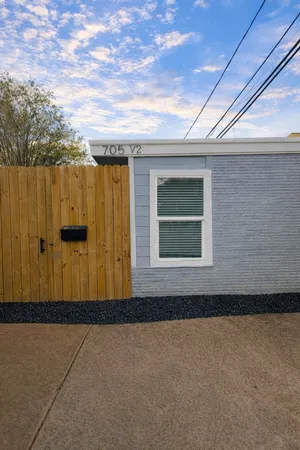 a view of a house with a wooden fence