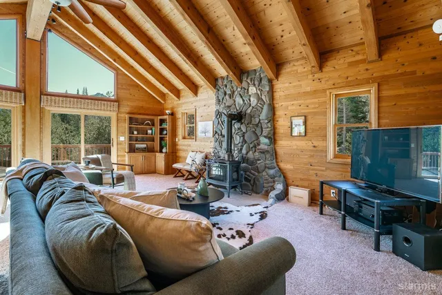 a view of a livingroom with furniture and floor to ceiling window