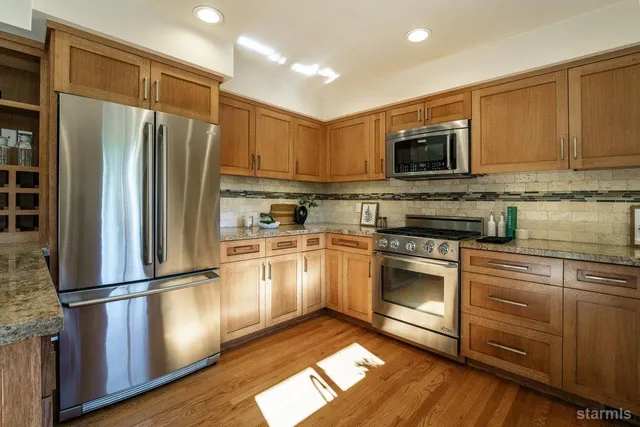 a kitchen with a refrigerator stove and microwave