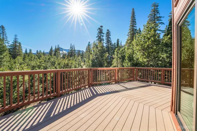 a view of balcony with wooden floor and fence
