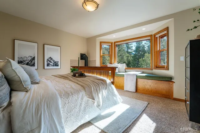 a bed room with a bed and a large window