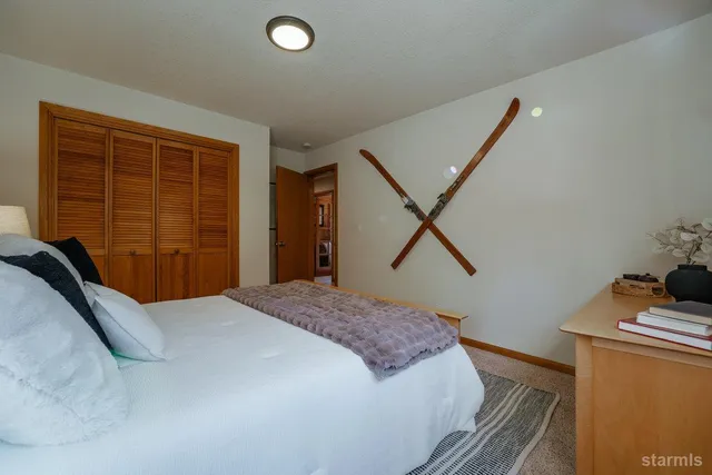 a bedroom with a bed and a dresser