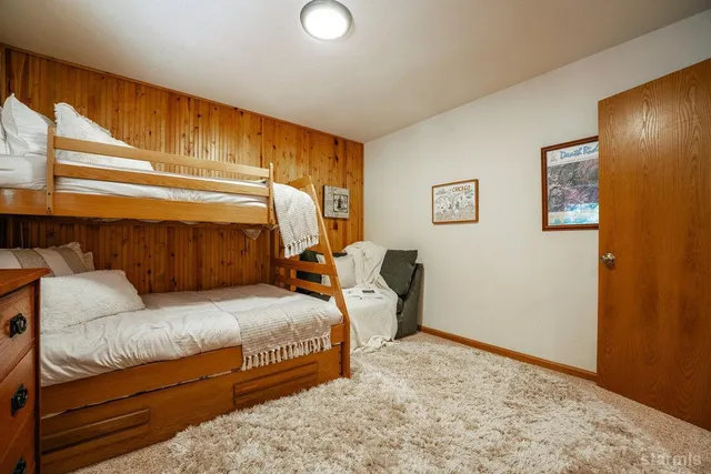 a bedroom with a bed and lamp