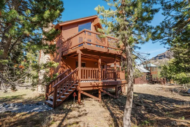 a view of a chairs with wooden fence and a bench
