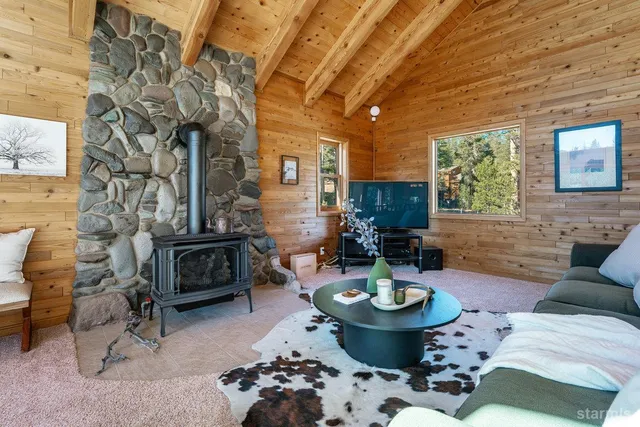 a living room with furniture a fireplace and a table