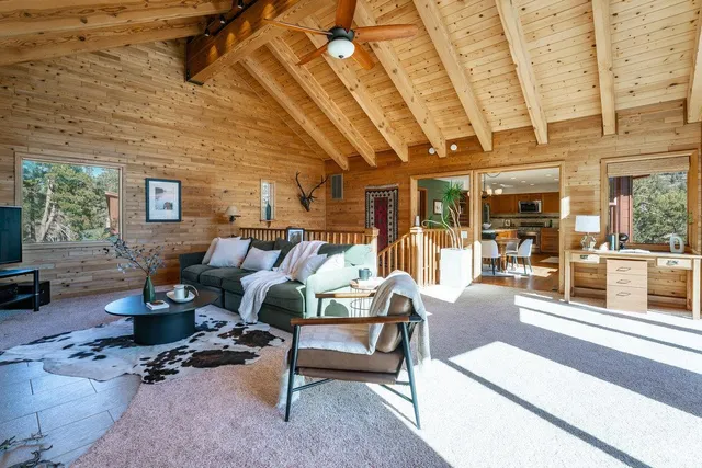 a living room with furniture wooden floor and a table