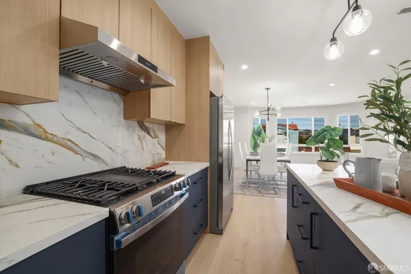 a kitchen with a stove and a refrigerator