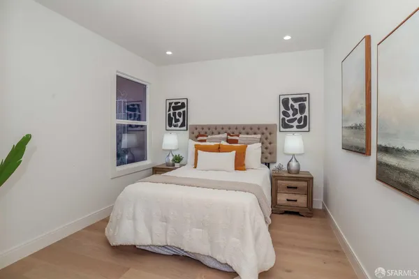 a bedroom with a bed and a wall painting