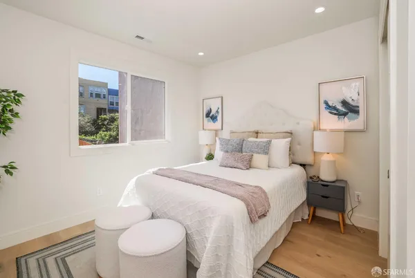 a bed room with a bed and a painting on the wall
