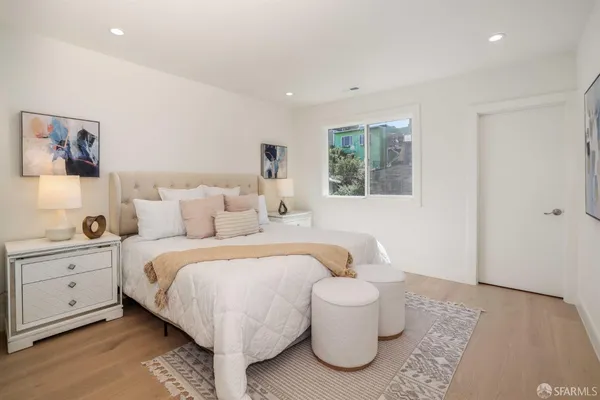 a spacious bedroom with a bed and a window
