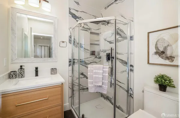 a bathroom with a sink toilet and shower